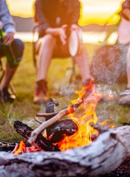 Camping bonfire surrounded by team of asian climbers hiker, they are playing music together in the forest path autumn season. Hiking, hiker, team, forest, camping , activity concept. Camping bonfire surrounded by team of asian climbers hiker, they are playing music together in the forest path autumn season. Hiking, hiker, team, forest, camping , activity concept.